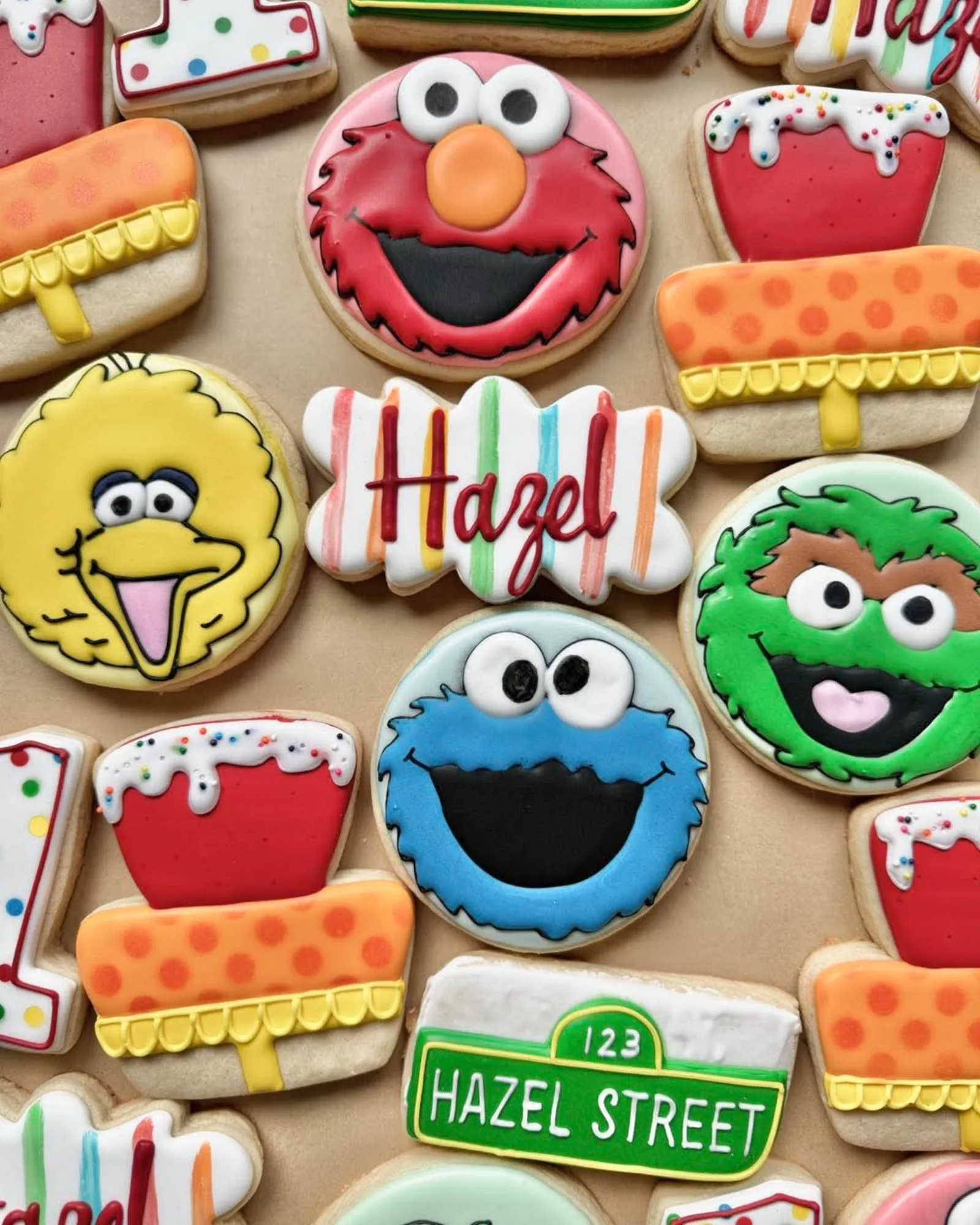 Sesame Street birthday cookies with Elmo, Big Bird, Oscar and Cookie Monster, plus a name plaque and a street sign.